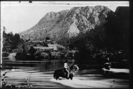 Horsemen cross the McCloud River near the salmon station, probably around 1882.National Archives 22-FFB-328