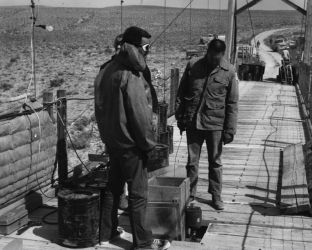 Agency personnel set up the detoxification station on the bridge in Browns Park, Colorado. Spreaders like the one in the middle of the picture were used to put potassium permanganate into the Green River.Photo by Rex Gary Schmidt. Courtesy of National Conservation Training Center. #4434