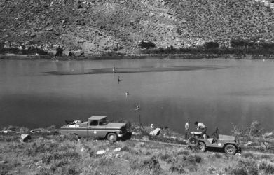 Setting up a rotenone drip station on the Green River in 1962.Photo by Rex Gary Schmidt. Courtesy of National Conservation Training Center. #4489